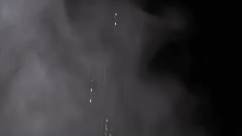 Falling Stream of Splashes on a Rising Cloud of Water Vapor on Black Background Stock-Footage 236191543