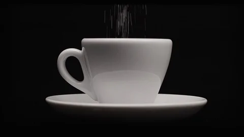 Falling sugar into a cup of coffee on dark background Stock Footage 120793479