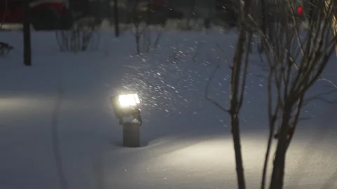 Falling tender snowflakes sparkle inside warm lantern glow Stock Footage 327809534