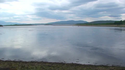 Falling tide water flow out of a loch Stock Footage 39654361