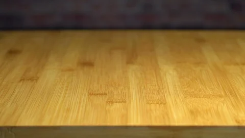 Falling tomato on wooden table, slow motion  Stock Footage 93961375
