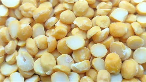 Falling uncooked dry yellow lentils into a wooden spoon on a wood surface i.. Stock Footage 272192811