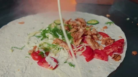 Falling vegetables and sauce on shawarma in slow motion. Video stock 137896211
