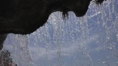 Falling water curtain view from behind waterfall Stock Footage 103971706