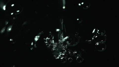 Falling water drop and circles isolated on black slow motion Stock Footage 272220986