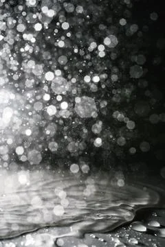 Falling water drops on a shadow background. Stock Photos