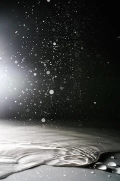 Falling water drops on a shadow background. Stock Photos