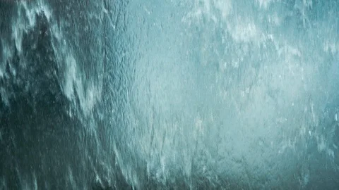 Falling water on a glass surface. Rainy day, extreme weather, flood concepts. Stock Footage 125287448