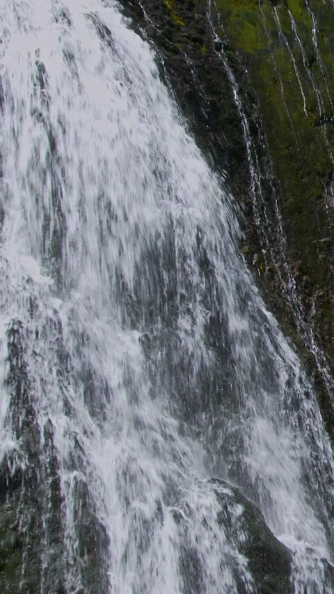 Falling Water Over Dark Wet Rock Close Up Vertical Video Stock Footage 346064986