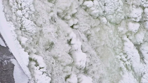 Falling water over iced up waterfall 01 Vidéo 234849078