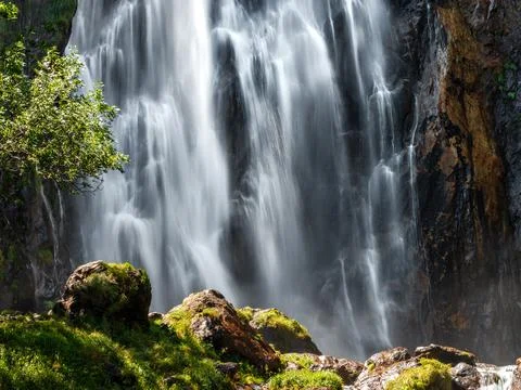 Falling water in a waterfall creates a cloud of water dust. Stock Photos