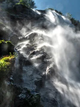 Falling water in a waterfall creates a cloud of water dust. Stock Photos