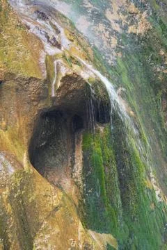 Falling waterfall with a grotto in the Chegem gorge Stock Photos