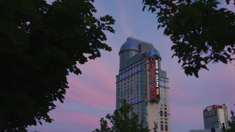Fallsview Casino Resort seen between trees, at sunset Stock Footage 218239768