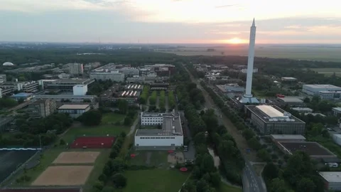 Fallturm Bremen drop tower eclipsing sun and campus aerial in warm sunset light Stockbeeldmateriaal 337970776