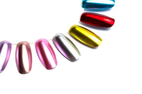 False multi-colored nails on a sampler on a white background. close up Stock Photos