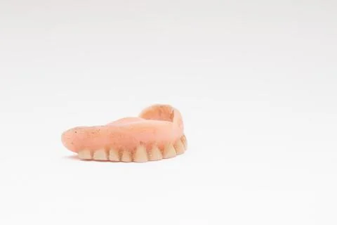 False teeth. Denture on a white background Stock Photos