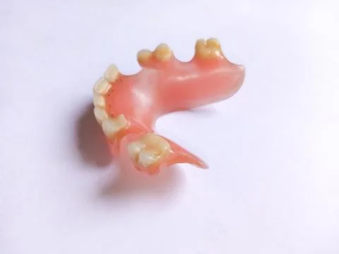 False teeth, Fake teeh or Dentures on a white background. Close-up of dentu.. Stock Photos