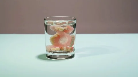 False teeth in a glass of water 動画素材 81194678