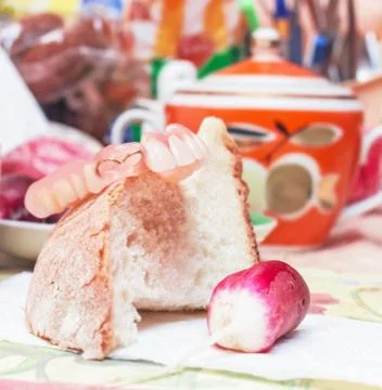 False teeth, white bread and radishes Stock Photos