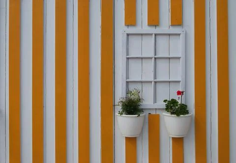 False window without glass on a wall with yellow vertical stripes Stock Photos