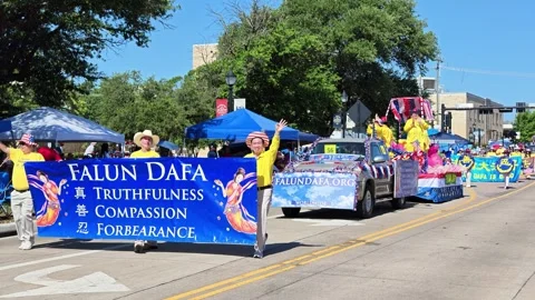 Falun Dafa parade float and banner procession on city street 스톡 동영상 340941707