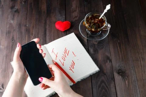 Famale write love sms Stock Photos