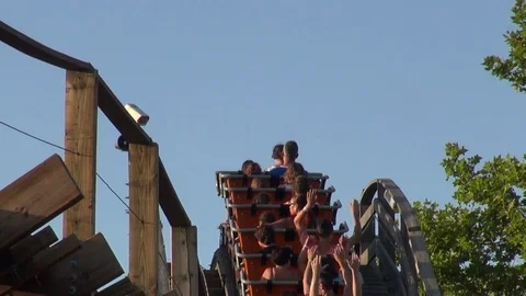Familiar roller coaster ride on an amusement park Vídeos de archivo 69734378