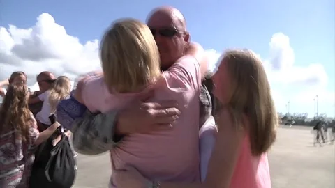 Families embrace on return from deployment Stock Footage 90164585