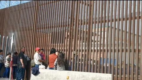 Families Wait at US Mexican Border Wall Seeking Asylum Separated Mexico Barrier Stock Footage