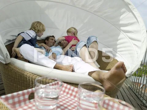 Familiy on sofa, out doors Stock Photos