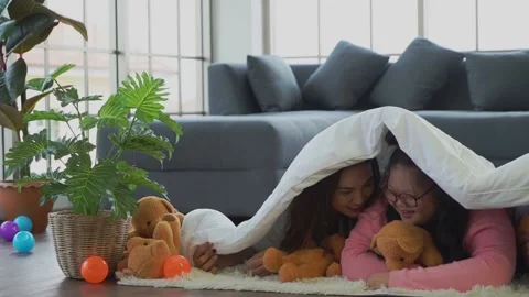 Family with Autism is playing under the blanket at home for disability child car Stock Footage