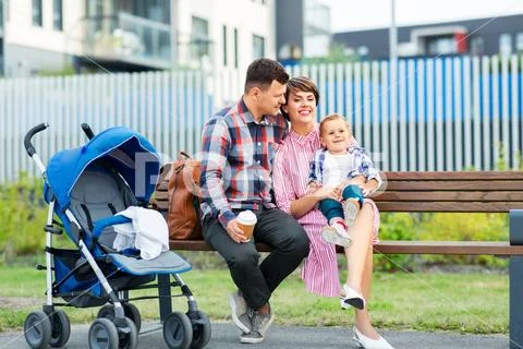 Family with baby in stroller and coffee in city Stock Photos