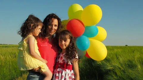 Family with balloons in nature. Stock Footage