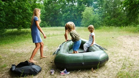 Premium stock video - Inflatable boats bumping each other on the beach