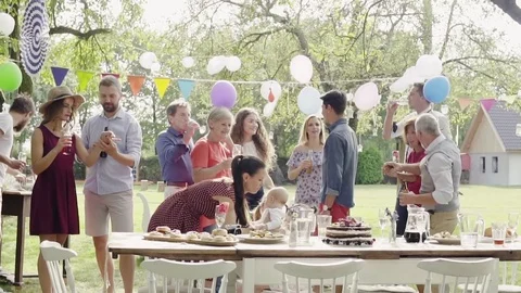 Family celebration or a garden party outside in the backyard. Stock Footage