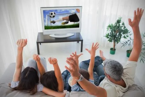 Family cheering and watching the world cup at home Stock Photos