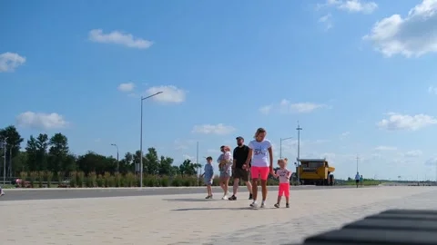 Family with child walking on paved path outdoors. Group of adults and kid m.. Stock Footage 337929313
