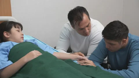 Family with children sick on the bed while mom and dad and sibling encourage Stock Footage 199549348