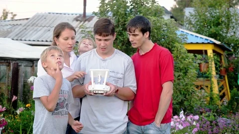Family with children using remote control for drone in the Park. slwo motion Video stock 85106743
