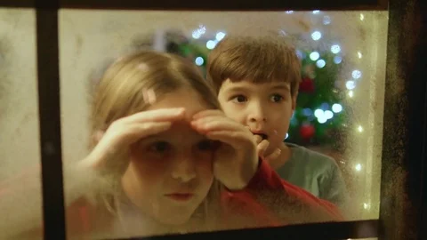 Family Christmas - Children Admiring Fireworks Through the Home Window Stock Footage