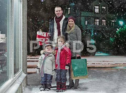 Family Christmas Shopping In Snow