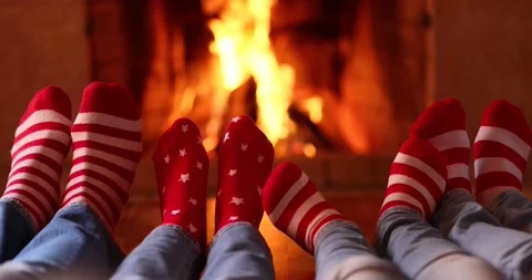 Family in Christmas socks near fireplace Stock Footage