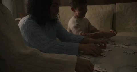 Family Collaborating on Strategy, Reaching Shared Goal. Jigsaw Symbolizes Stock Footage 311406990