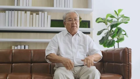 Family concept of 4k Resolution. An elderly Asian man is giving an interview  Stock Footage 147565634