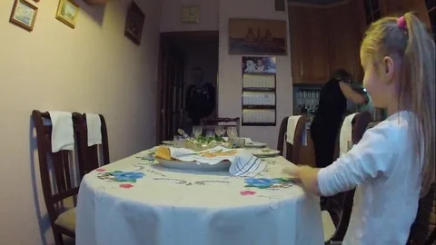 Family covers festive table in the kitchen and sits down to eat and celebrate Stock Footage 69237485
