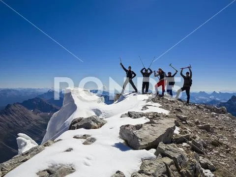 A Family Creating A Funny Pose While Hiking In The Rocky Mountains