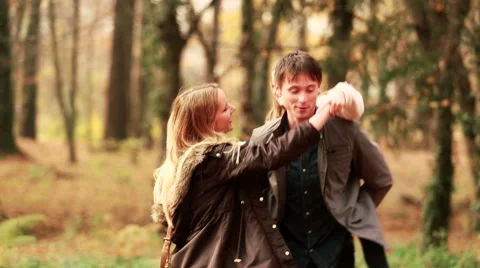 Family dancing in park, father carrying daughter on his back Stock Footage 59554406