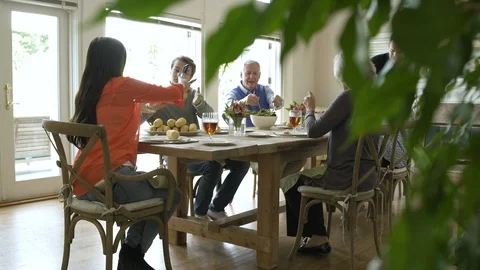 Family dining together at dining table. Stock Footage 88021174
