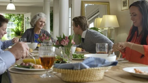 Family dining together at dining table. Stock-Footage 88021390